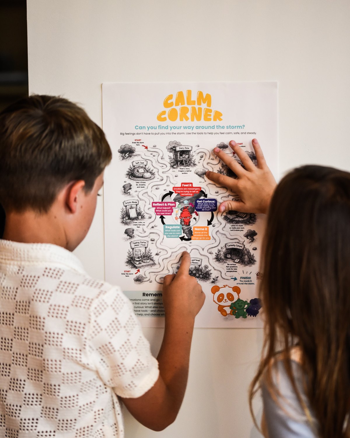 Two kids trace the path on the My Mama Says Calm Corner storm maze poster