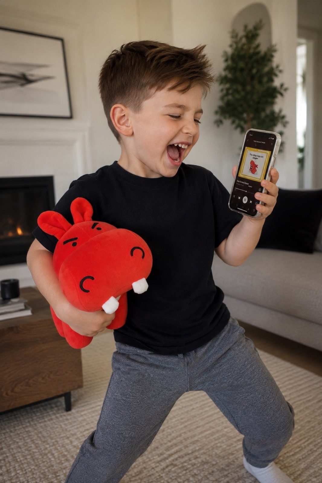 Boy playing with the angry hippo plush at home