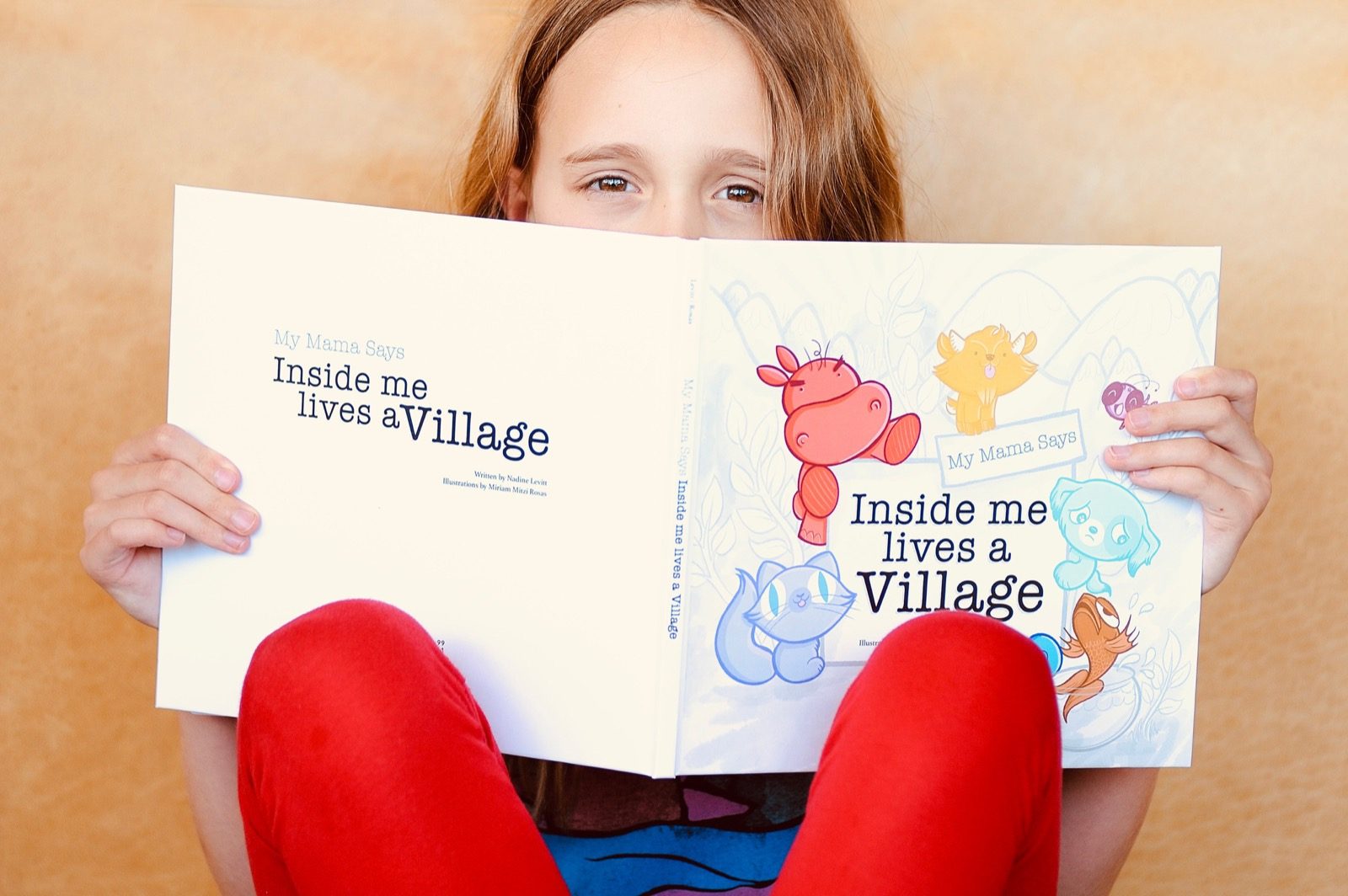 Child reading Inside me lives a village from the anger kit