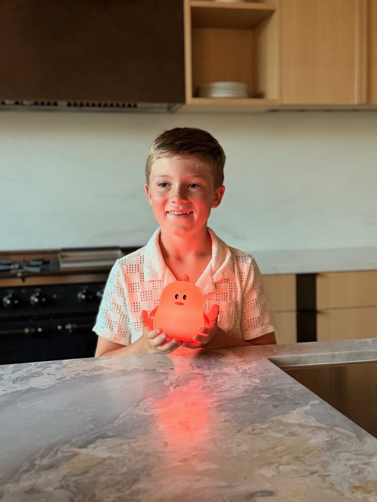Boy holding the scared penguin nightlight from the fear kit