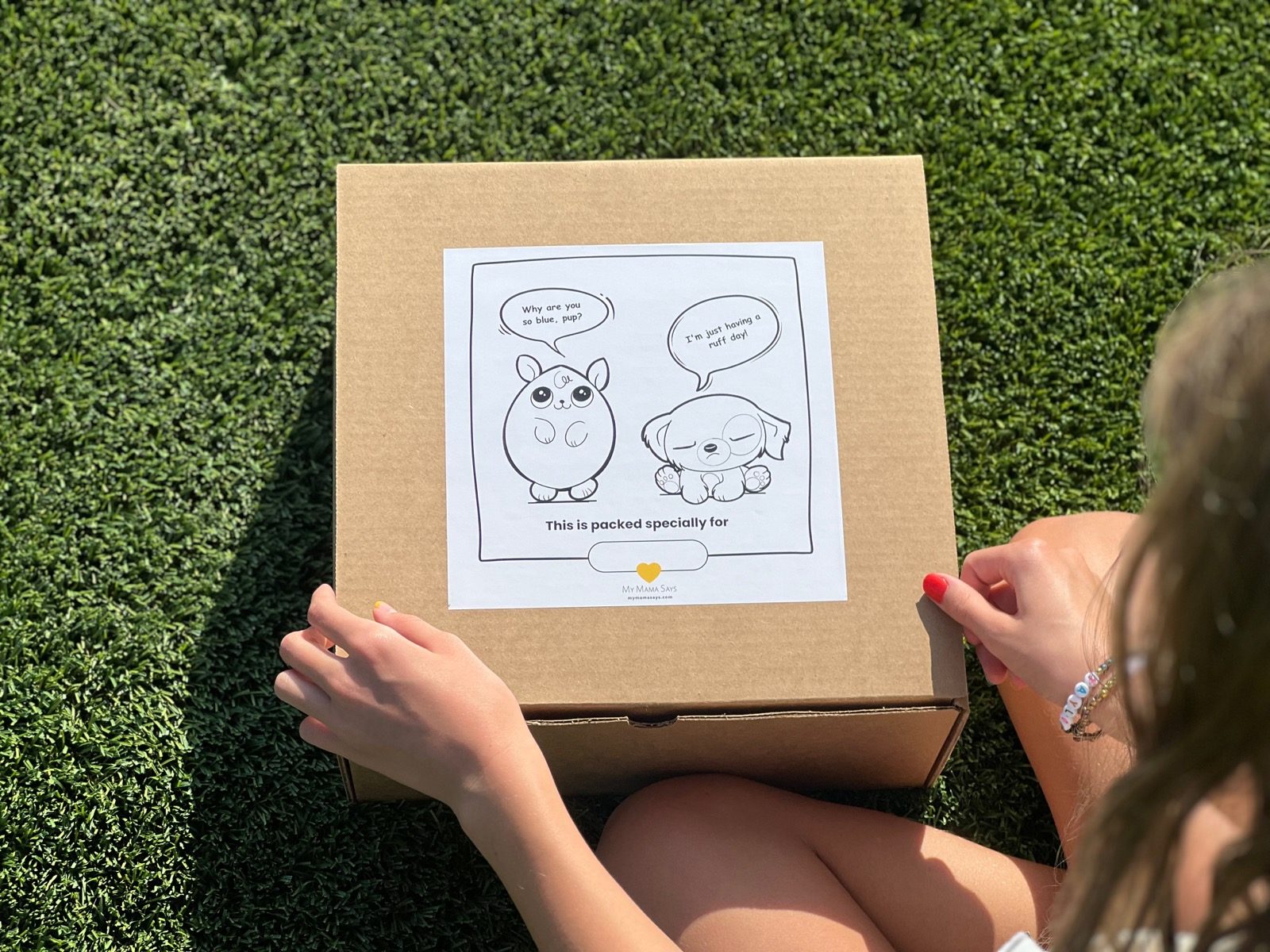 Child with the My Mama Says anger kit box on the grass