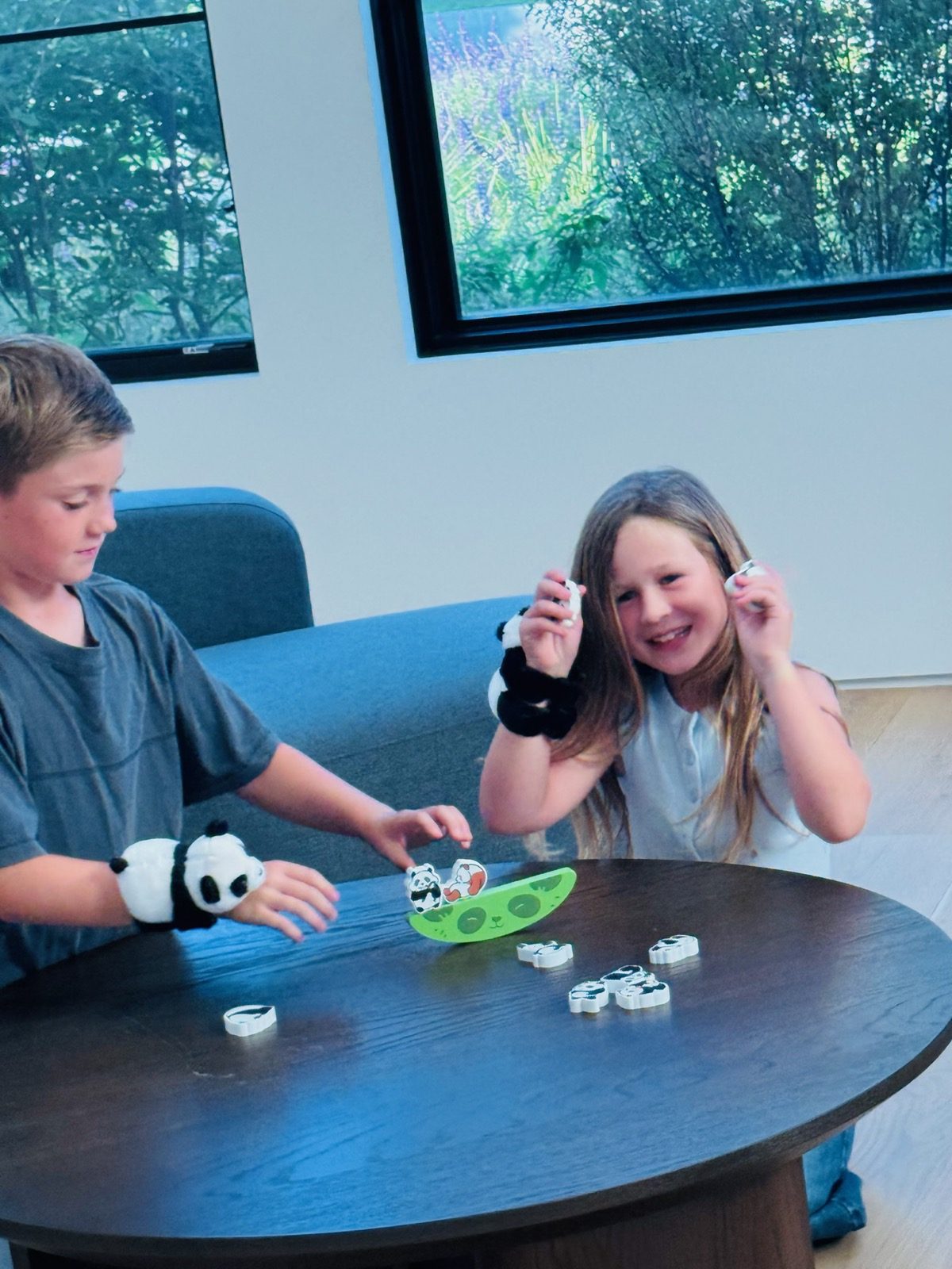 Two kids playing the panda balancing game